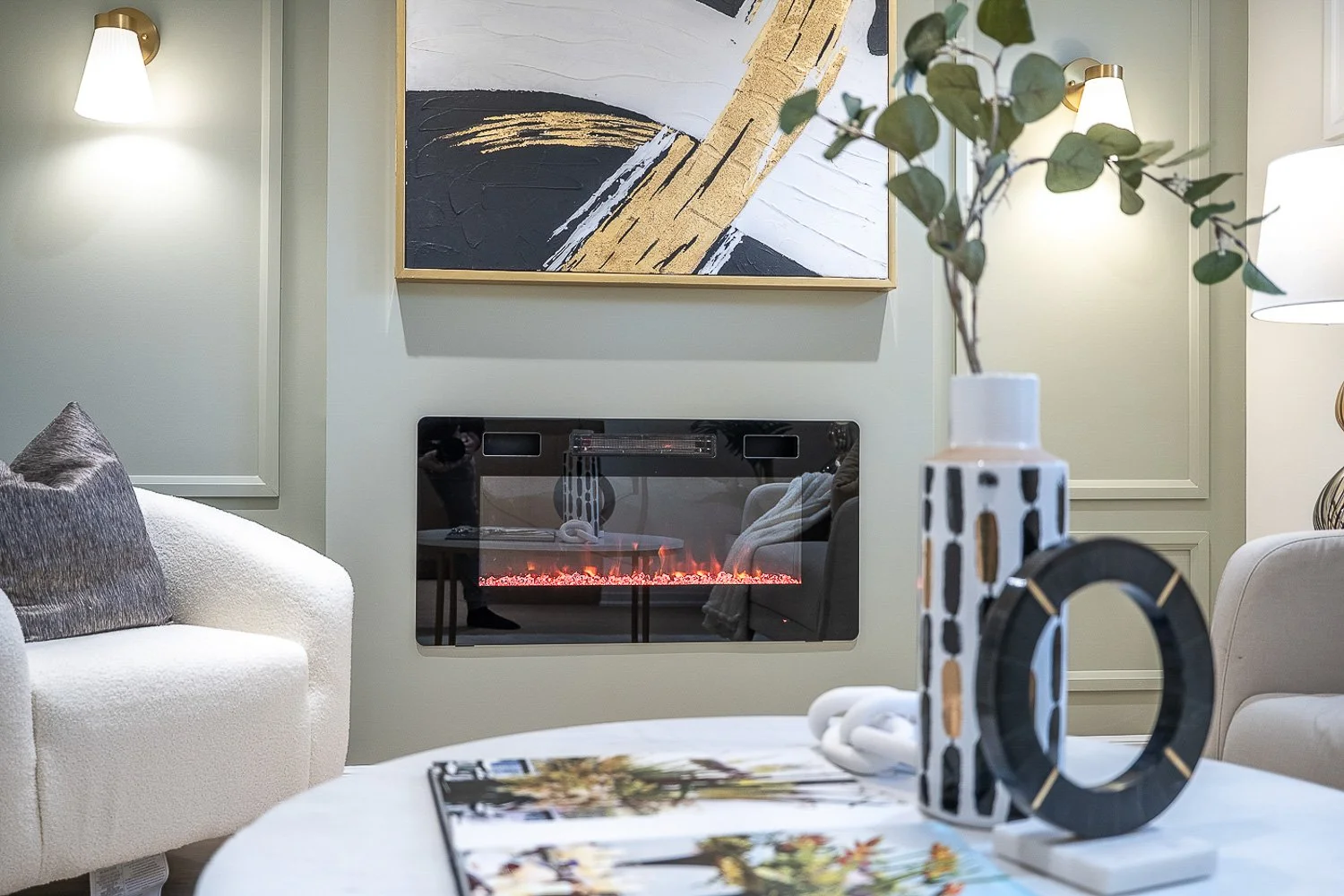Modern living room with sleek electric fireplace, custom wall moulding and contemporary décor