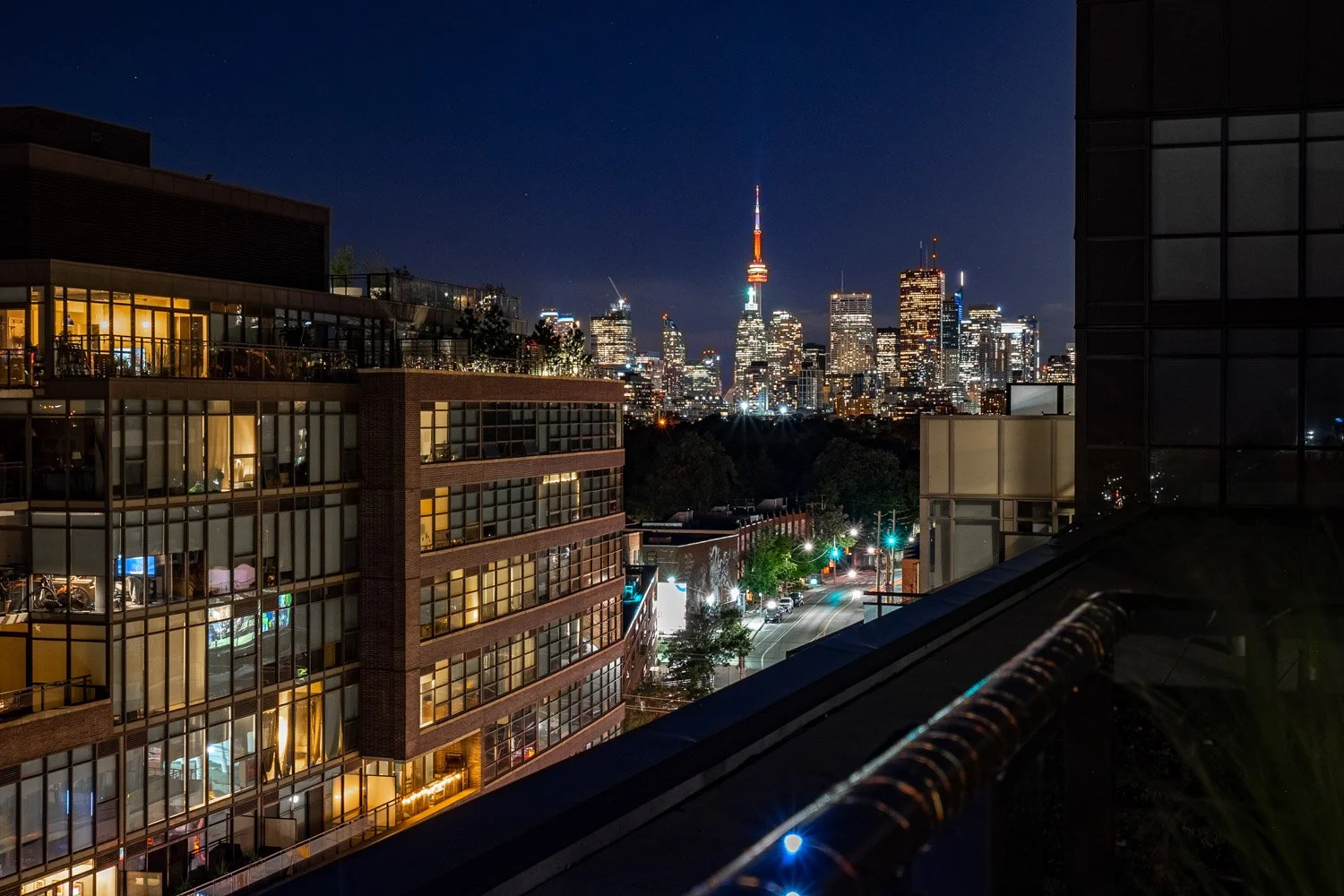 Night view of the Toronto skyline and CN Tower from a condominium balcony