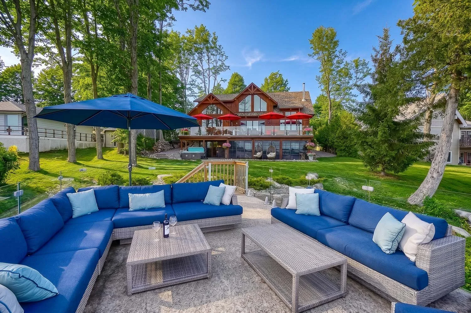 Luxury waterfront backyard with outdoor lounge and lakefront home