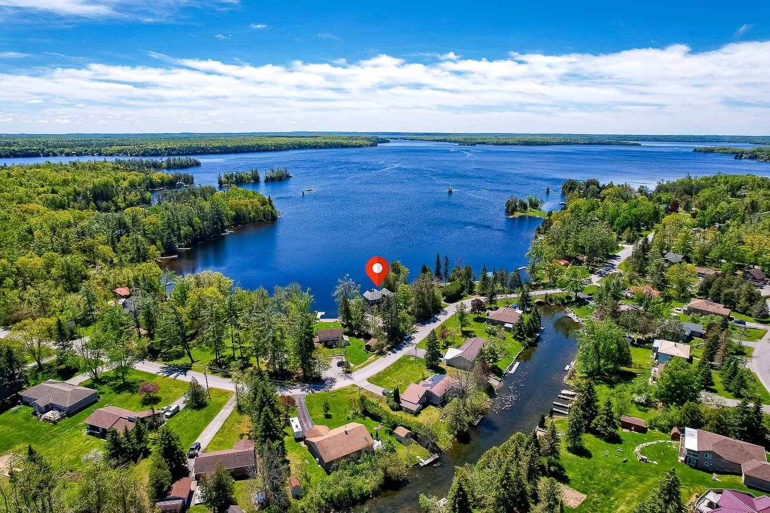 Aerial view of luxury waterfront home on scenic lake