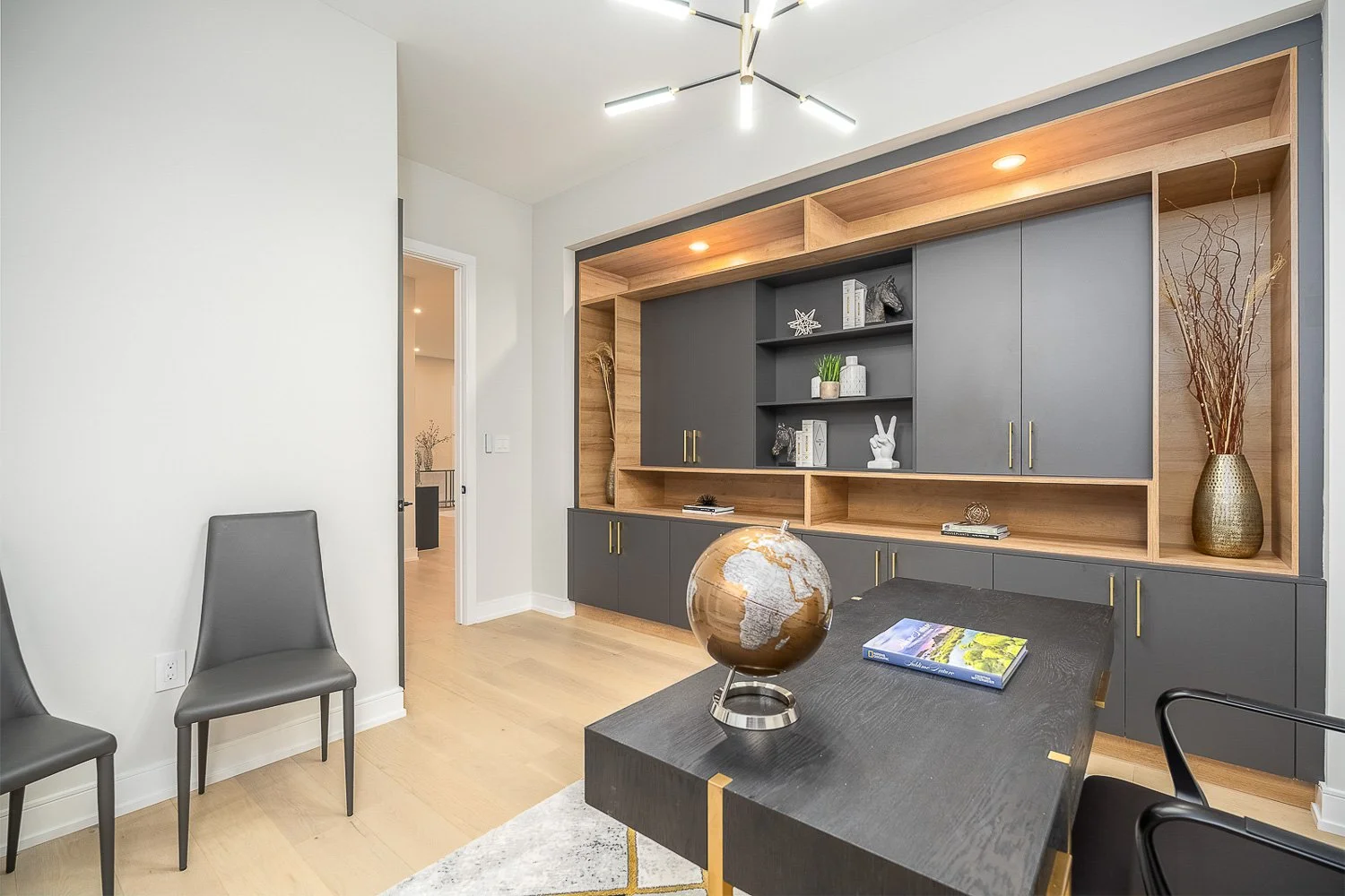 Dedicated home office with custom built-in cabinetry, open shelving, and contemporary finishes, offering a stylish and functional workspace for working from home.