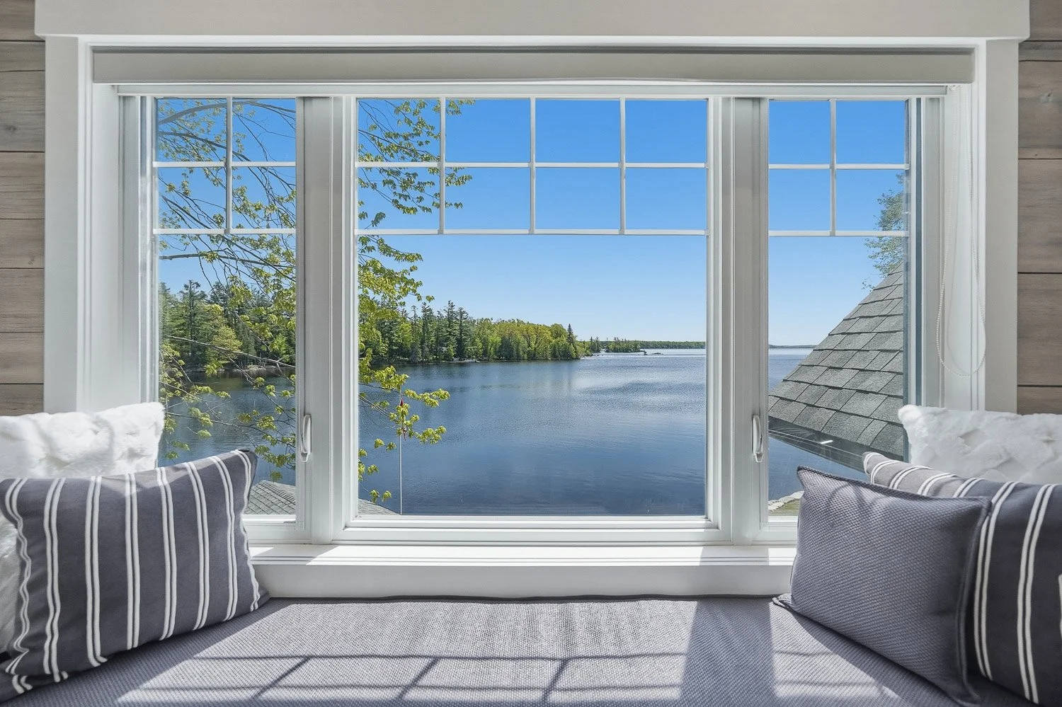 Cozy window seat with panoramic lake view and abundant natural light