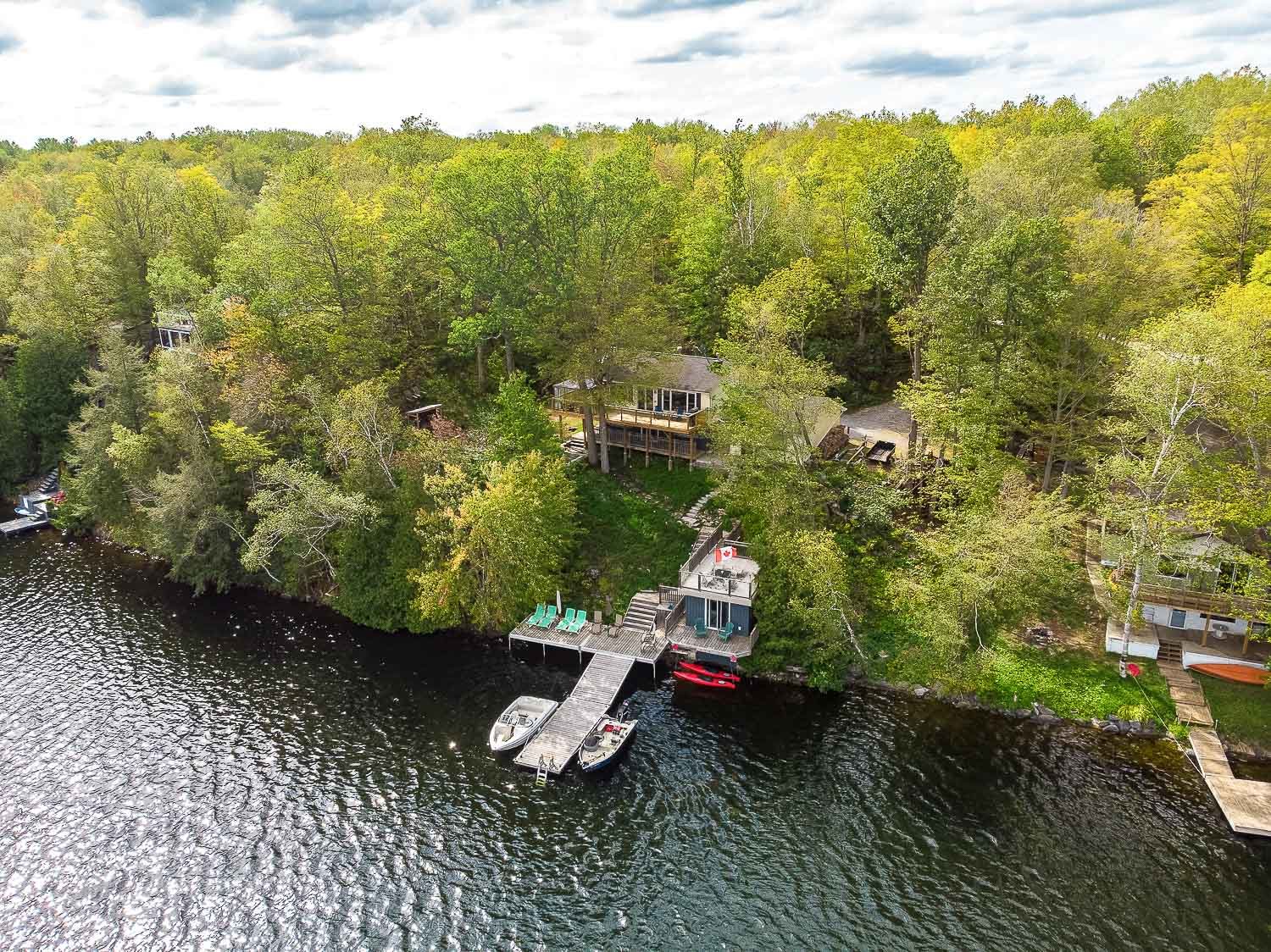 Aerial view of secluded waterfront cottage with private dock