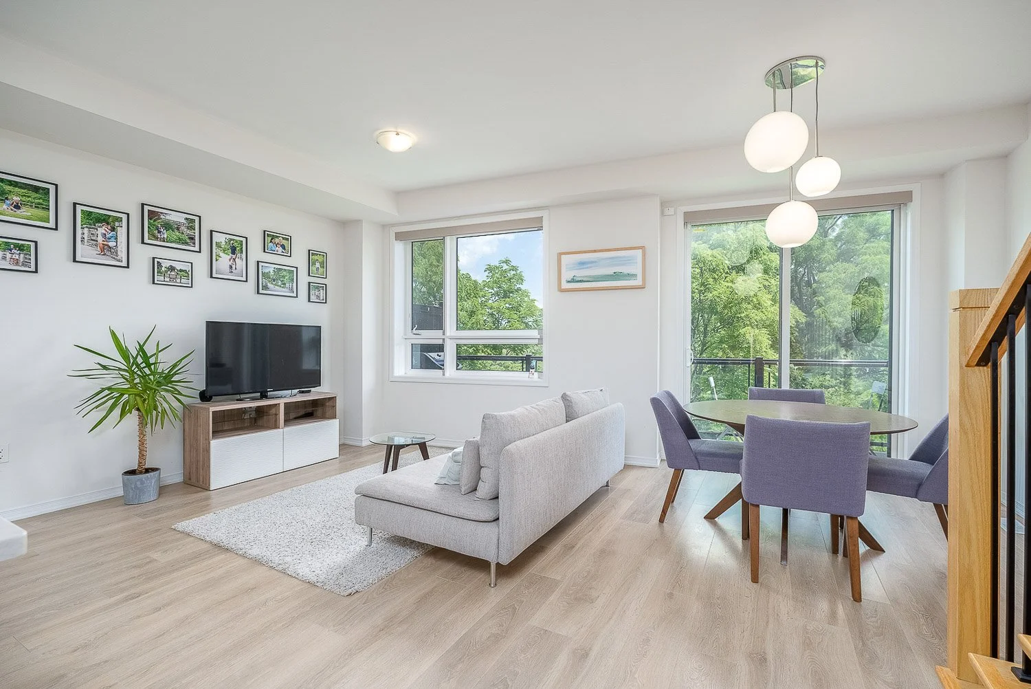 Bright open-concept living and dining area with oversized windows, abundant natural light, and contemporary finishes, professionally photographed for a Toronto real estate listing