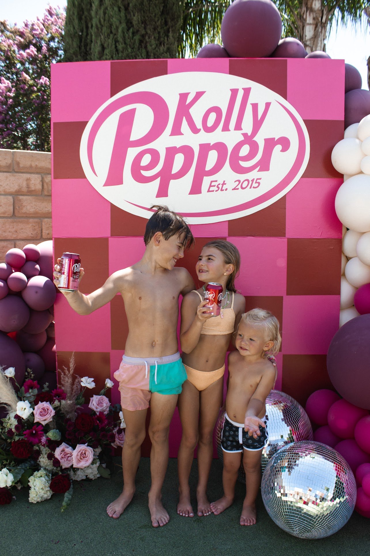 three kids taking a photo at the Kolly Pepper decor