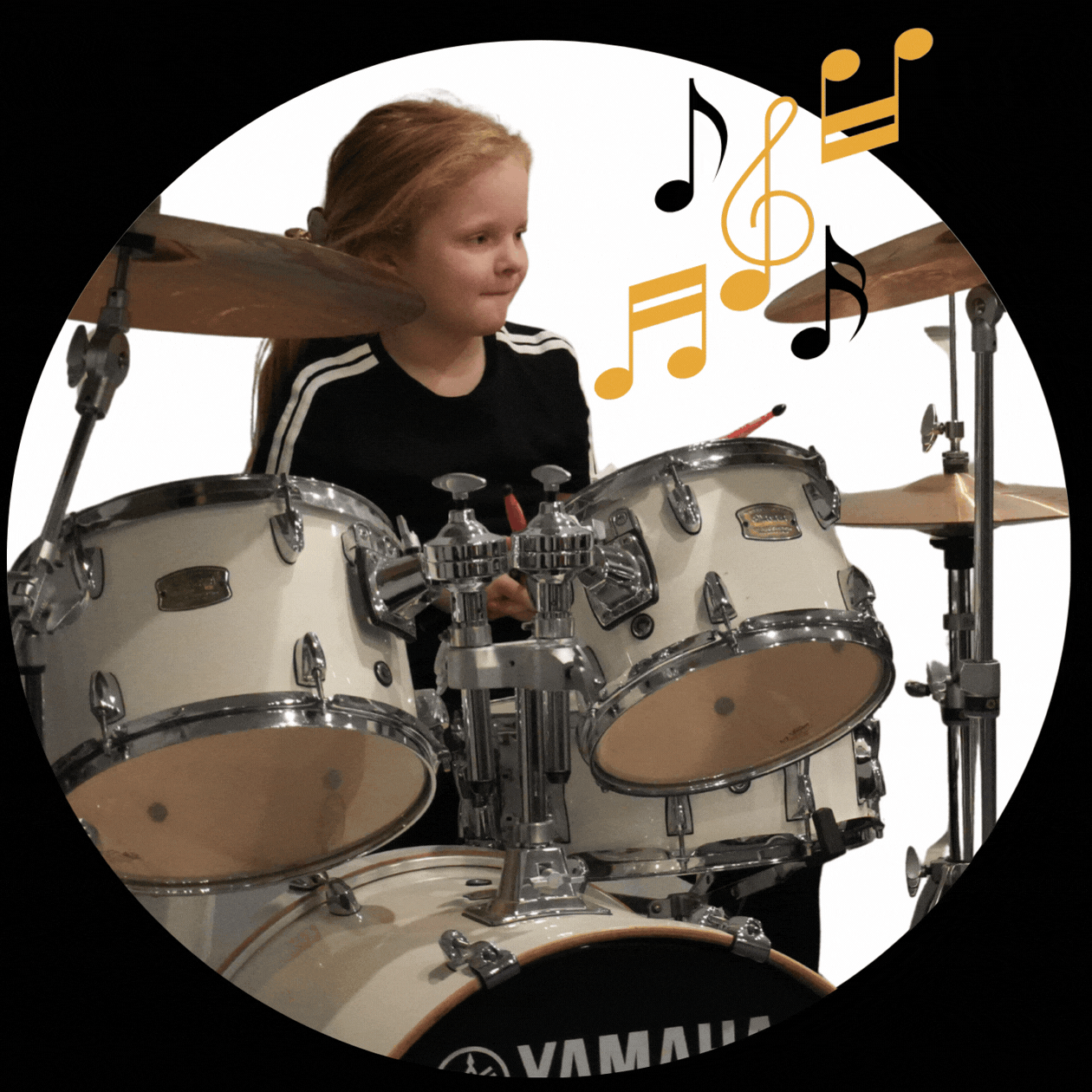 A Young perso sitting at a drum kit getting ready to play a performance