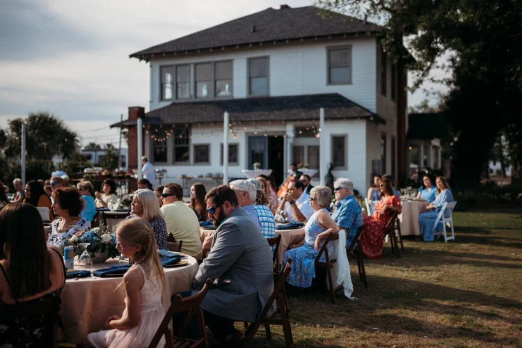 Guests at an outdoor reception on the lawn
