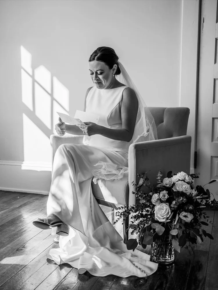 Bride reading a letter in the bridal suite