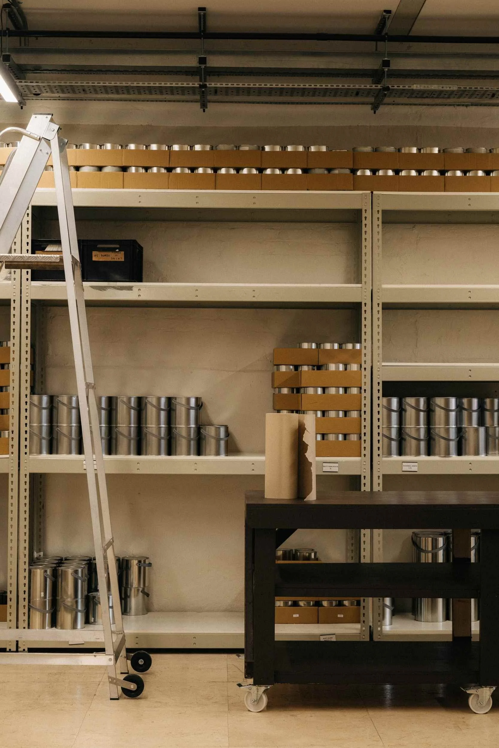 Shelves of paint tins at the Atelier Ellis studio.