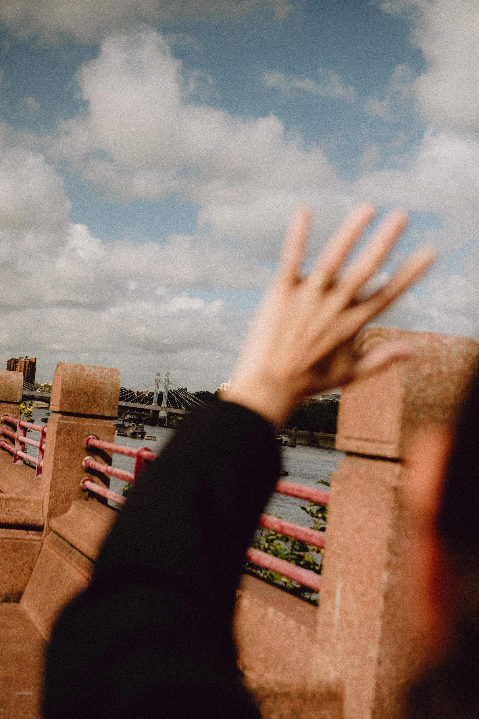 Woman waving Hello to London.