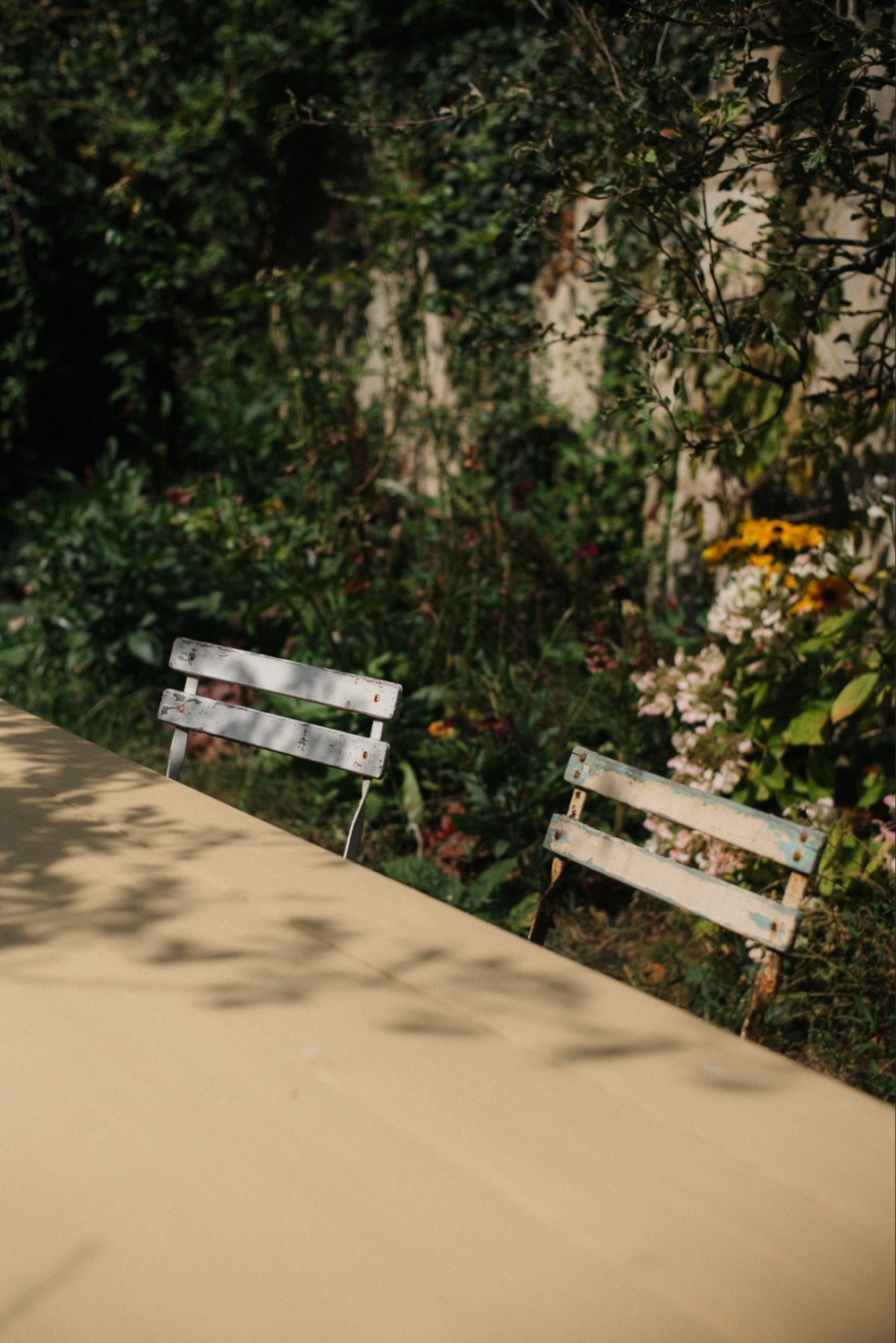 Garden table painted in Sadhika, a golden yellow colour by paint brand Atelier Ellis.
