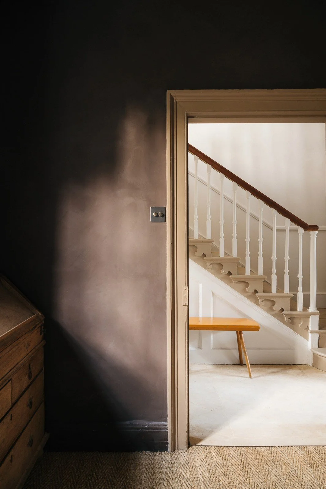 Room painted in Atelier Ellis' Fallen Plum, with Zumai open door and staircase.