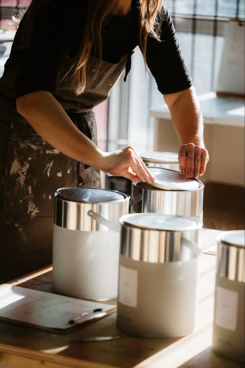 AE employee packing up tins of breathable paint.