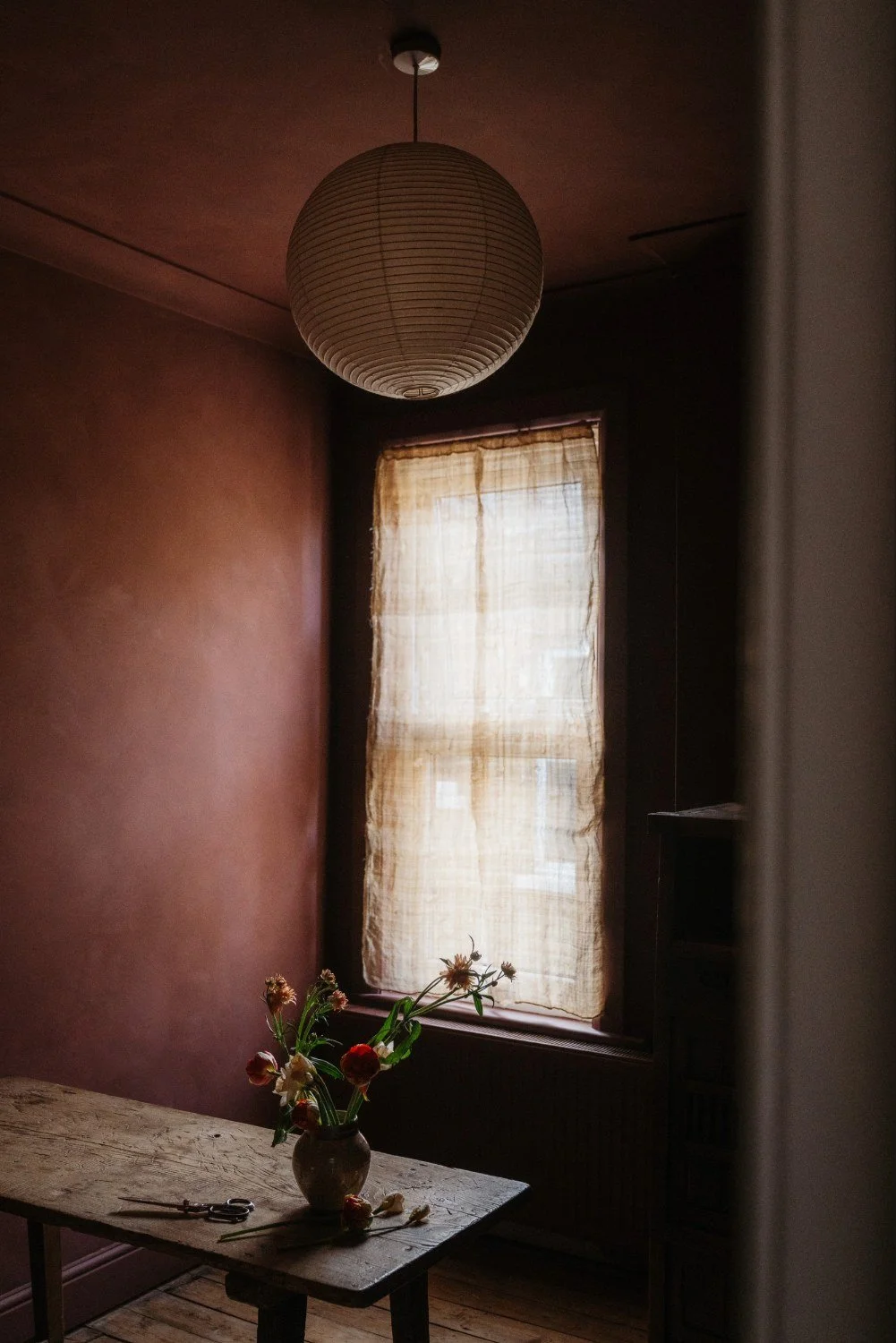 Room drenched in the breathable paint colour Lundenwick, a deep red colour.