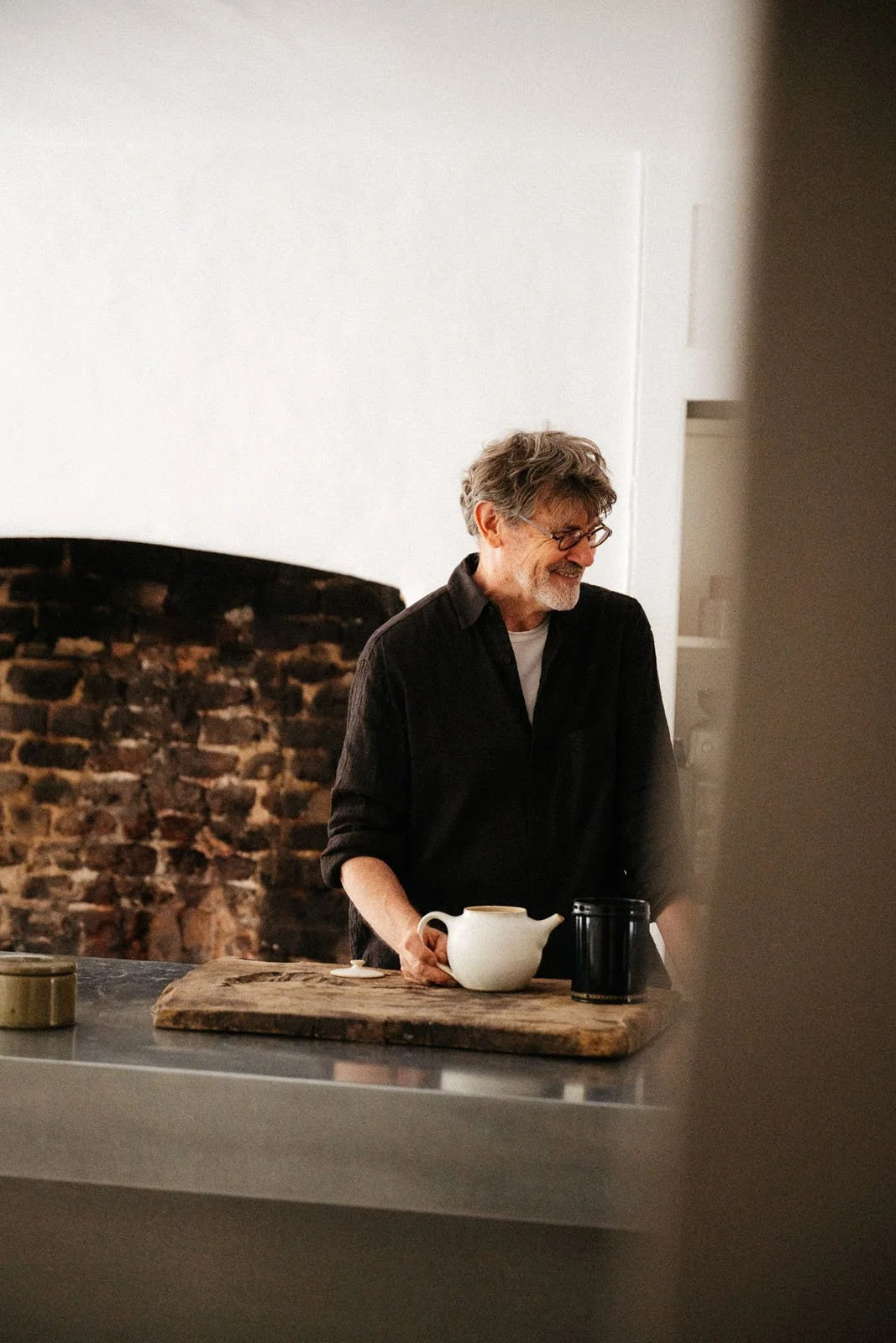 Cook and writer Nigel Slater standing in his kitchen painted in Foundation, our simplest white paint colour.