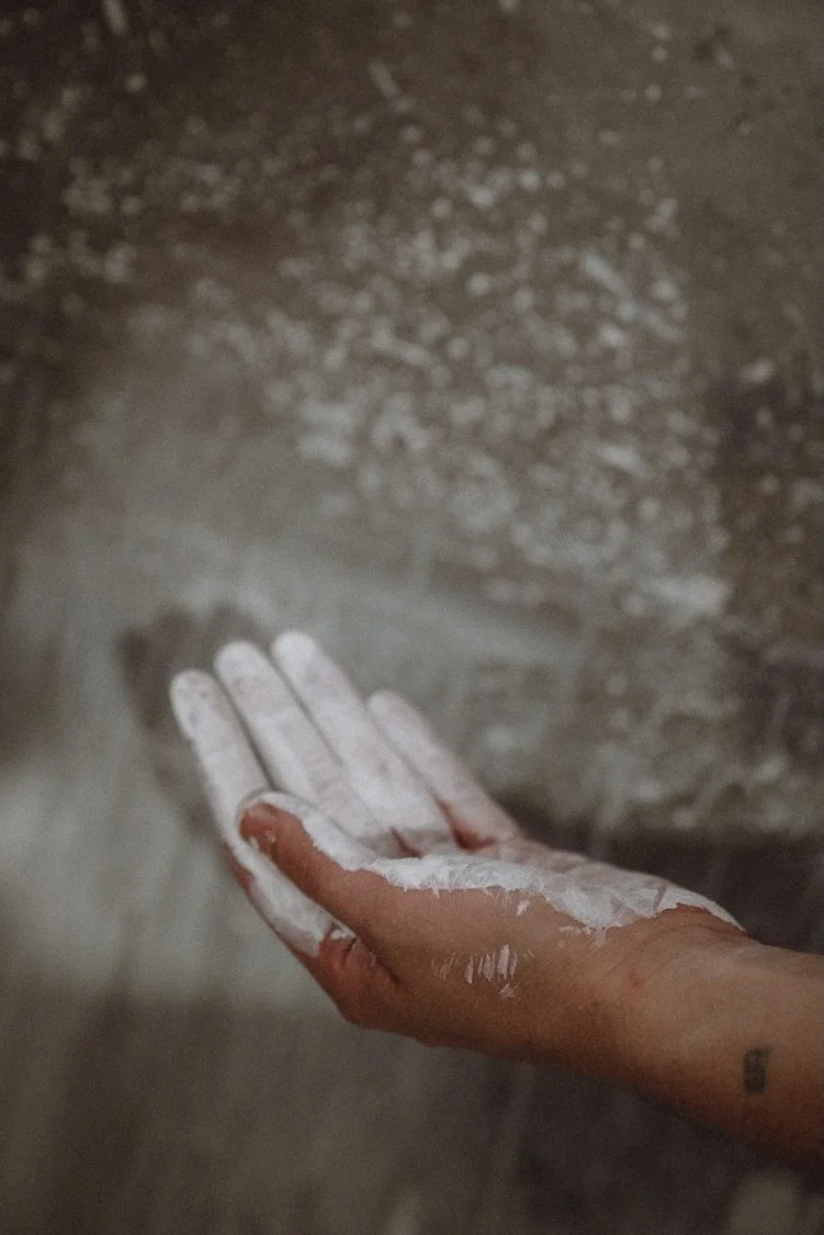 Hand covered in pigment as a result of making paint.