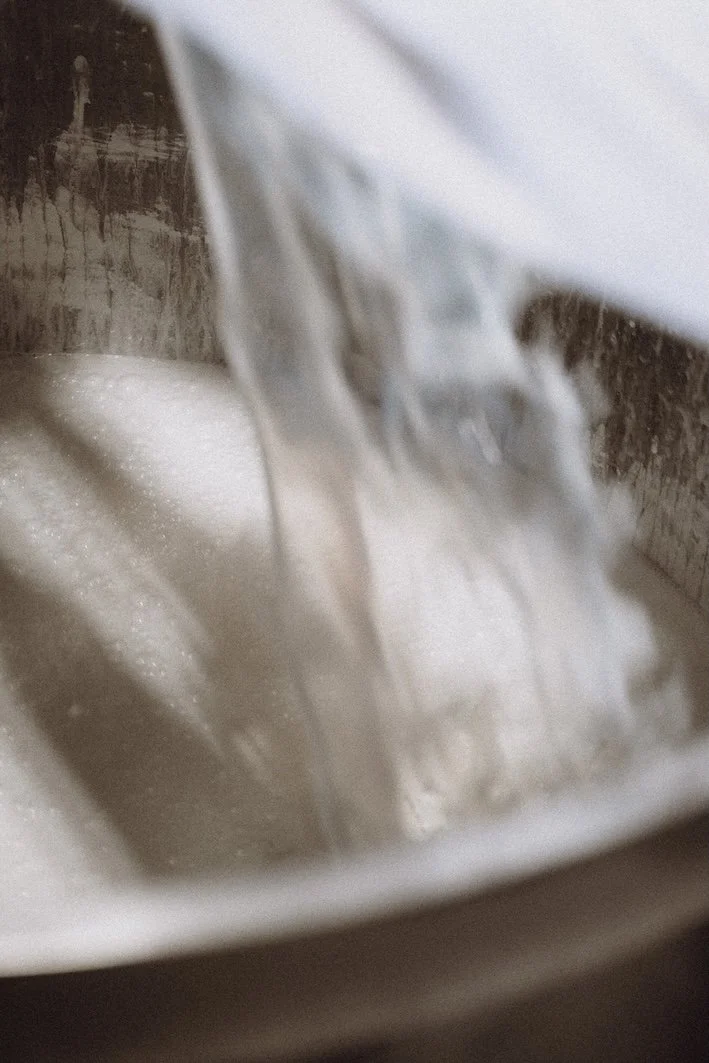 Paint being poured in a vat.