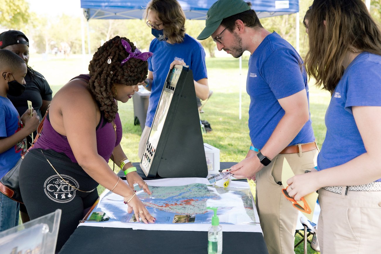  Volunteers engage with participants with map and natural trivia 
