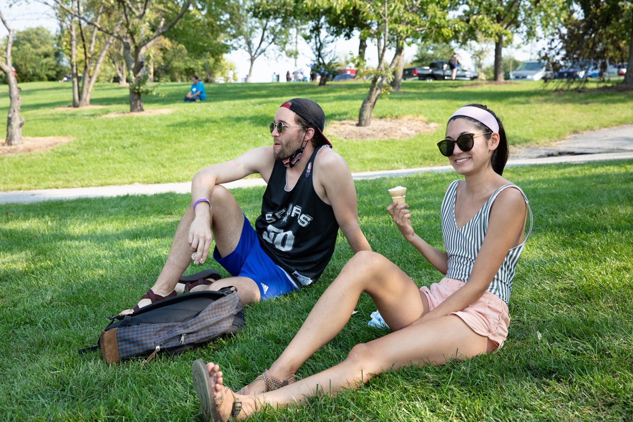  Couple eats ice cream and sits on grass 