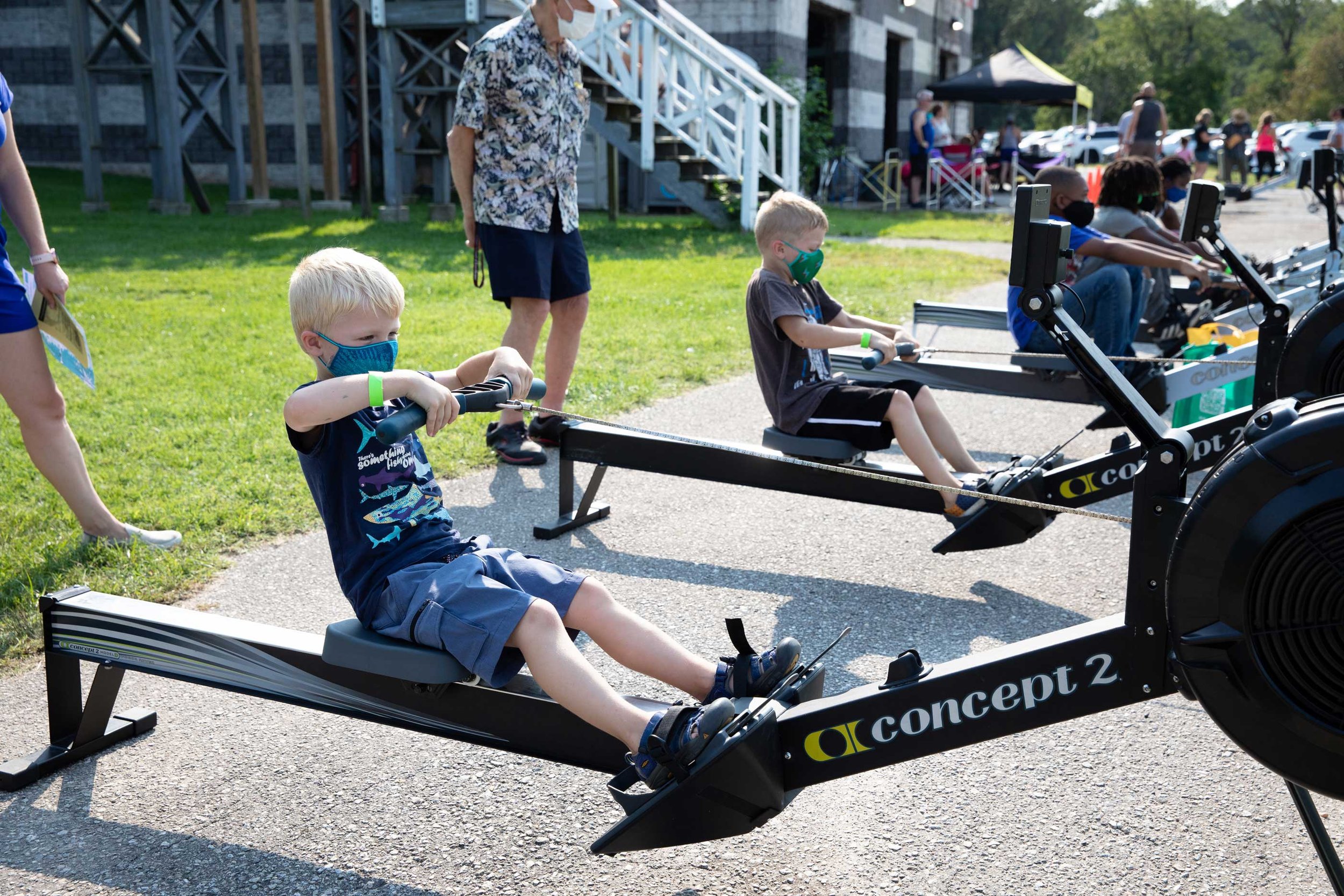  Kids practice using rowing machines outside 