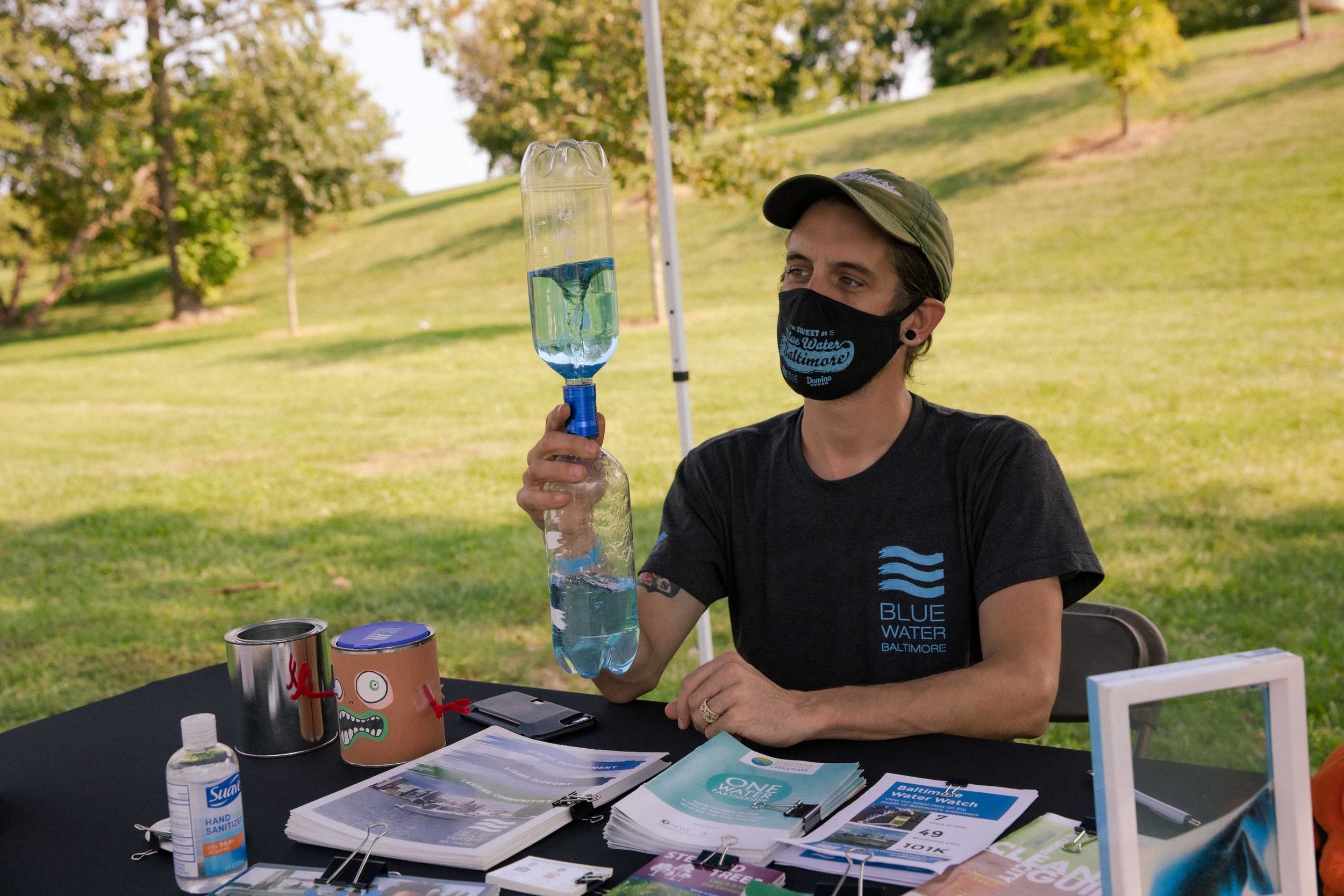  Blue Water Baltimore volunteer in tent demonstrates how whirlpools work 