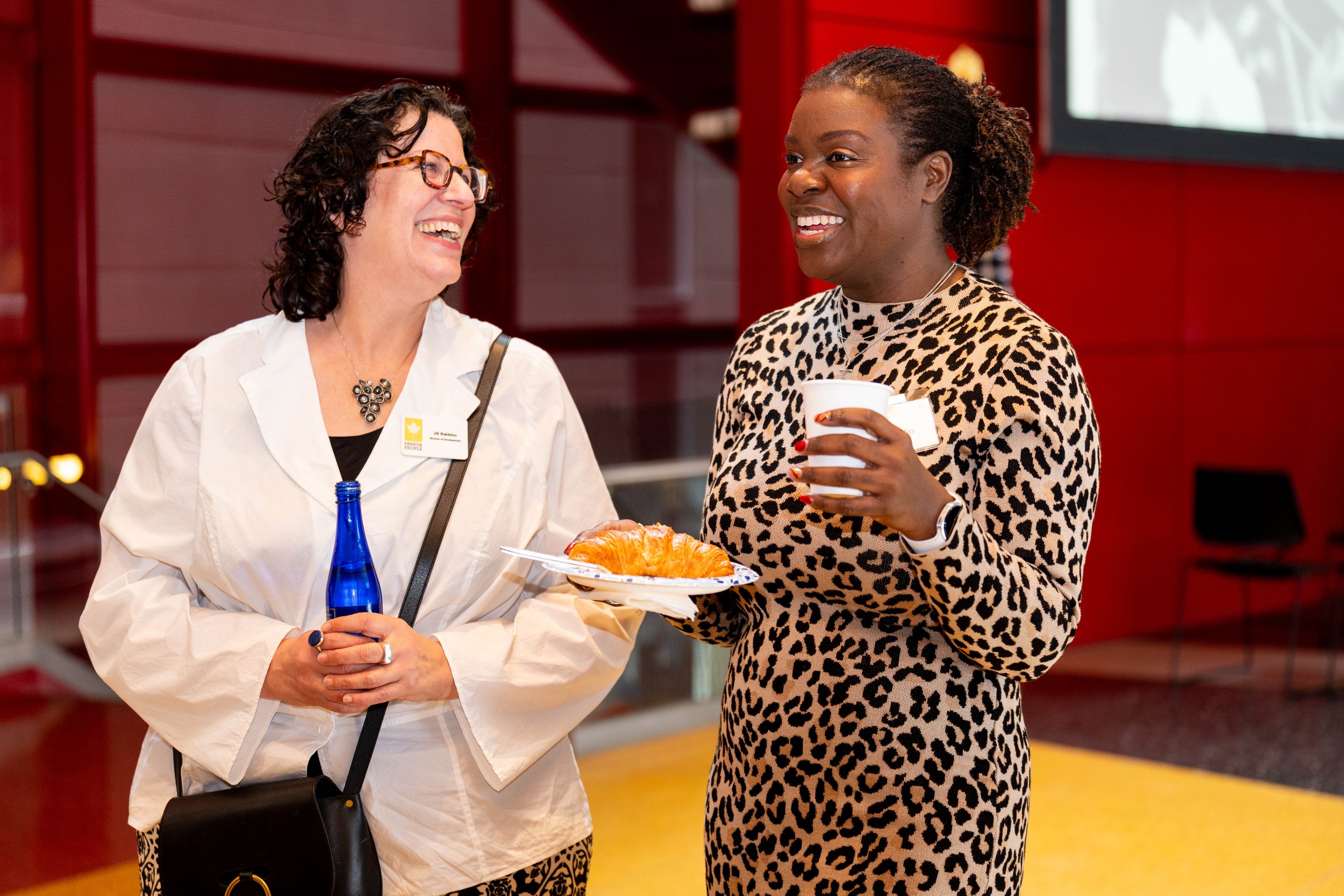 Attendees laugh together during the event reception.  