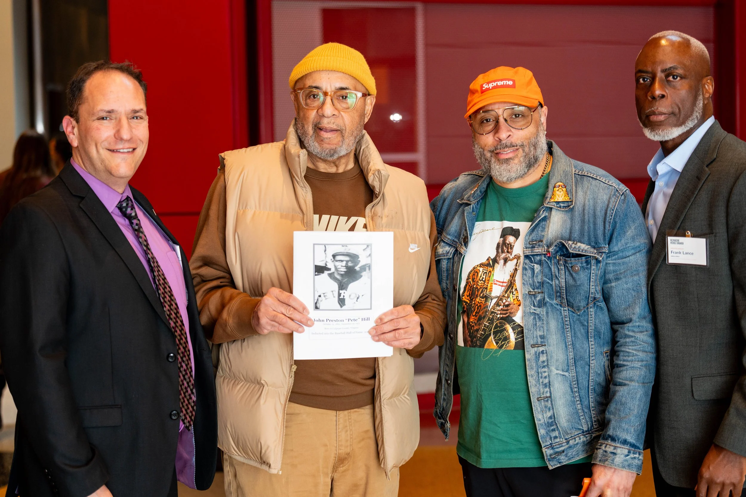  (L) Brad Rogers, Executive Director of South Baltimore Gateway Partnership, poses with Ron Hill and Frank Lance (R). Hill is holding a book about his Great Uncle, Pete Hill.   