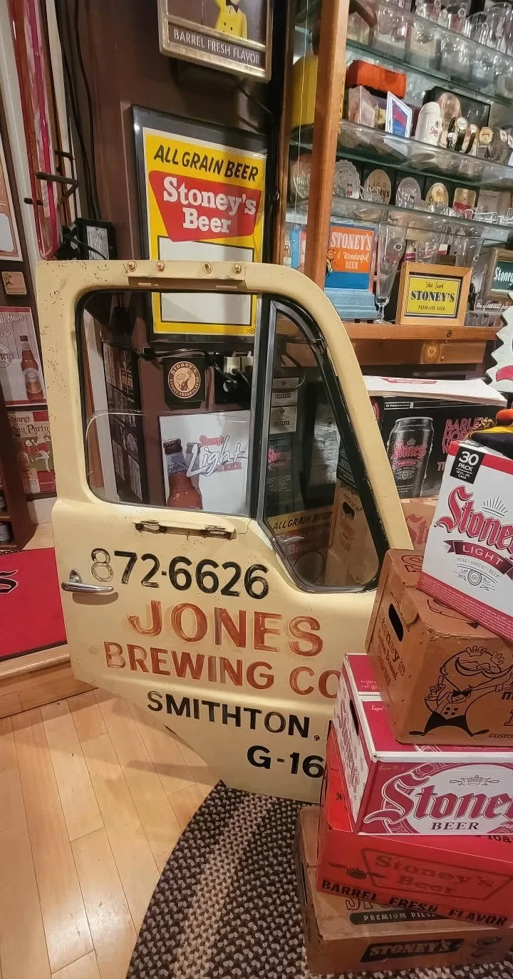 Jones Brewing Co. Smithton crate beside vintage Stoney's signs