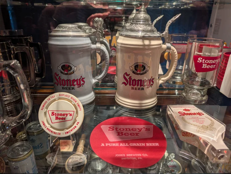 Vintage Stoney's Beer lidded steins and a Pure All Grain Beer round sign