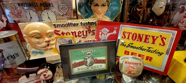 Vintage Stoney's Smoother Tasting signs and a character face mug