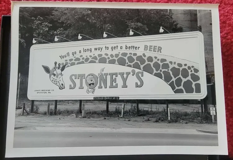 Black-and-white photo of a Stoney's giraffe billboard
