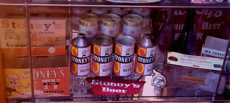 Stacked cone-top and flat-top vintage Stoney's cans