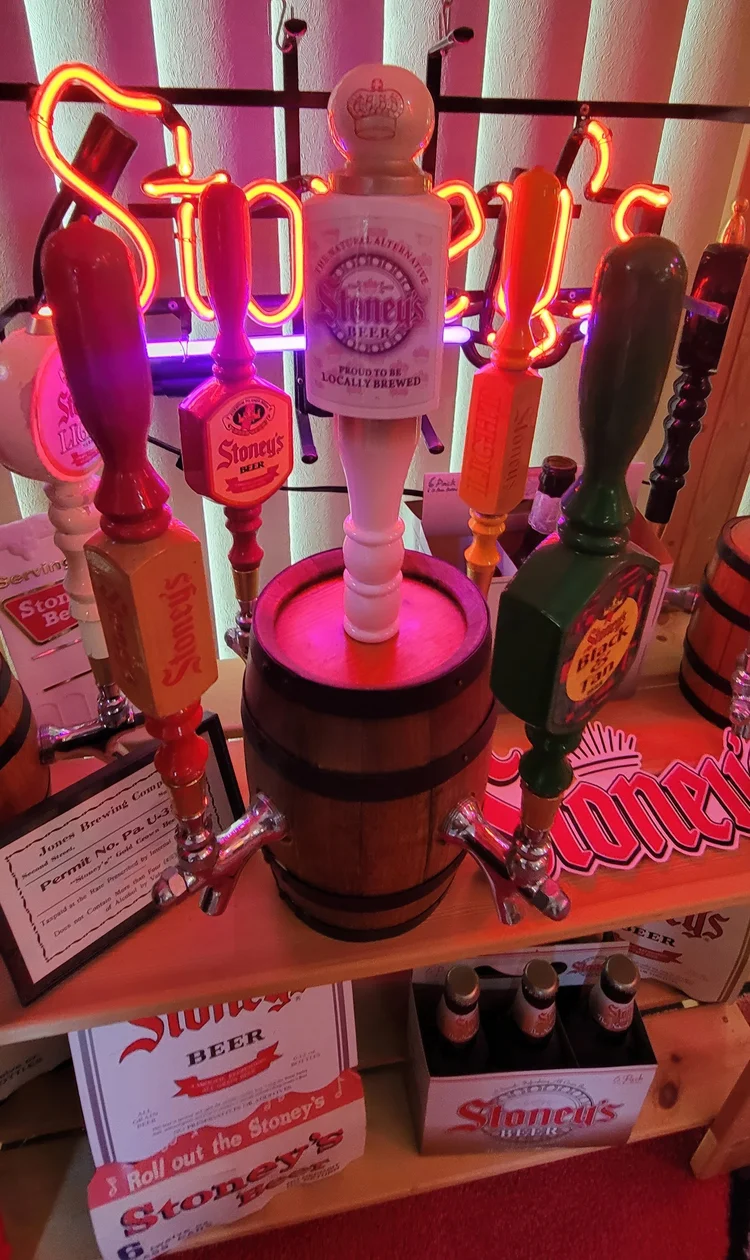 Stoney's tap handles and neon above a barrel display