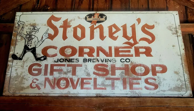 Weathered tin sign for Stoney's Corner Gift Shop and Novelties, Jones Brewing Co.