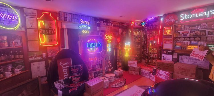 Collection room glowing with Stoney's neon signs