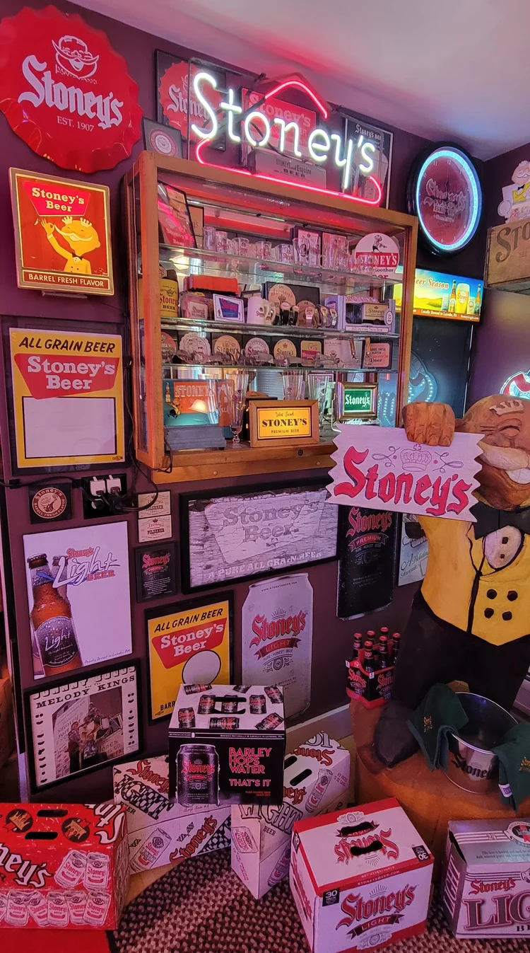 Floor-to-ceiling wall of vintage Stoney's advertising