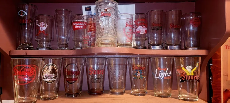 Row of vintage Stoney's beer glasses on a shelf