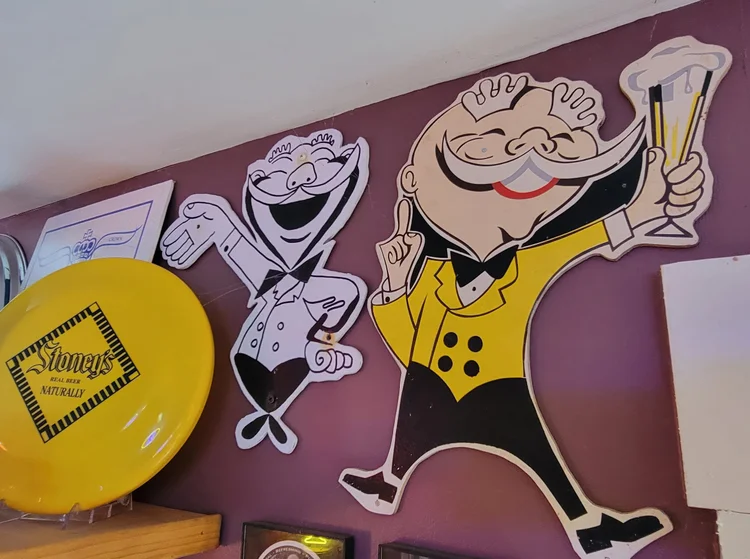 Two vintage Mr. Smoothie cutout figures beside a Stoney's tray