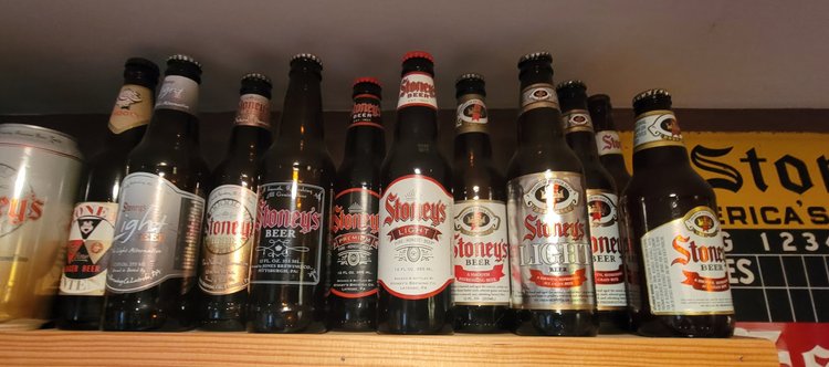 Row of vintage Stoney's bottles on a wooden shelf