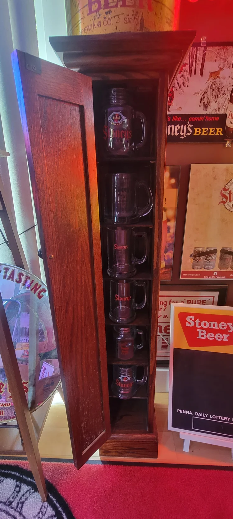 Tall lit display case of Stoney's memorabilia