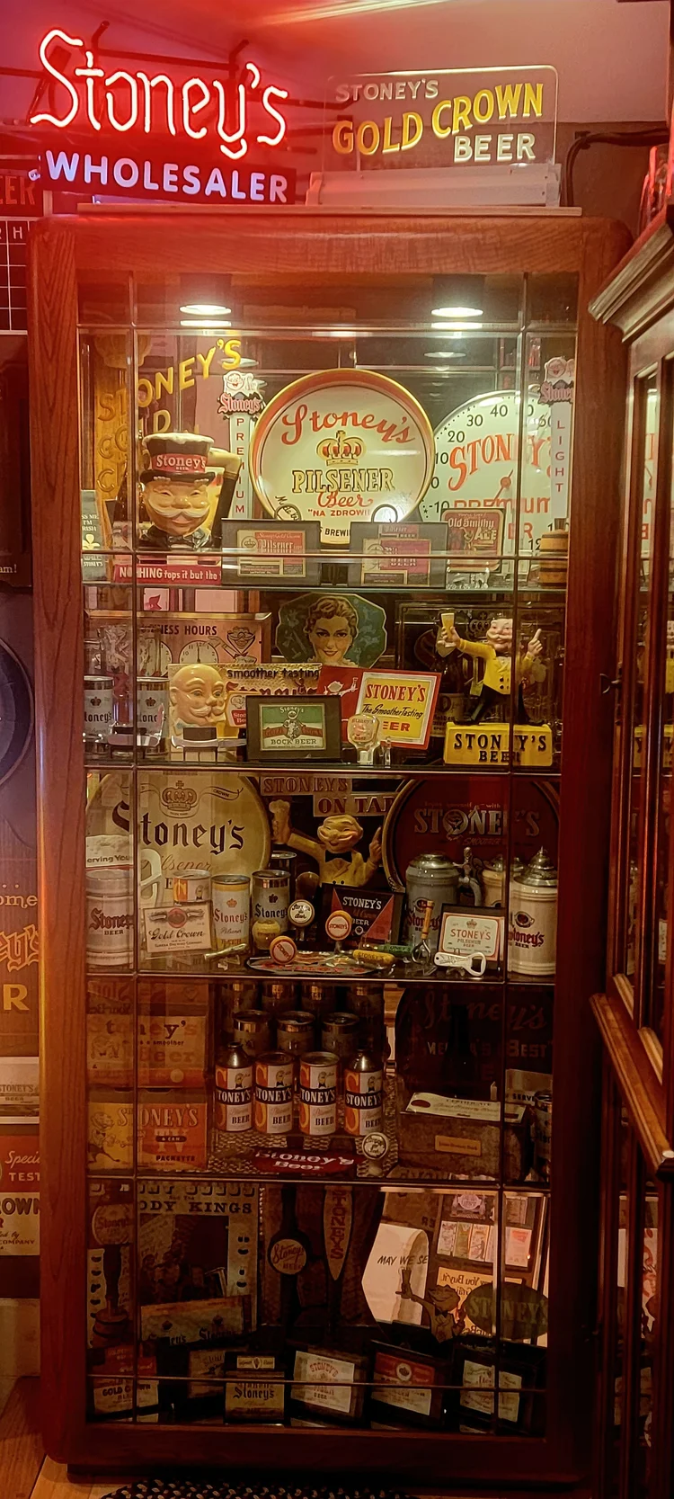 Tall lit case of Stoney's Wholesaler memorabilia