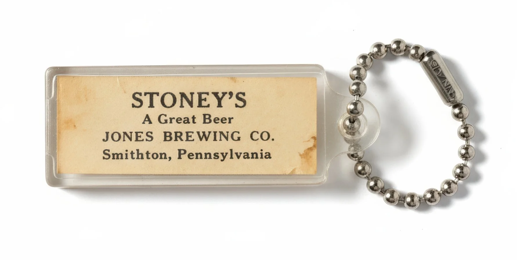 Vintage Stoney’s Beer keychain from Jones Brewing Co. Smithton, Pennsylvania with acrylic case and metal bead chain.
