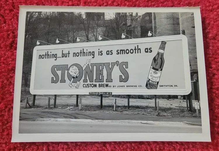 Black-and-white photo of a vintage roadside Stoney's billboard