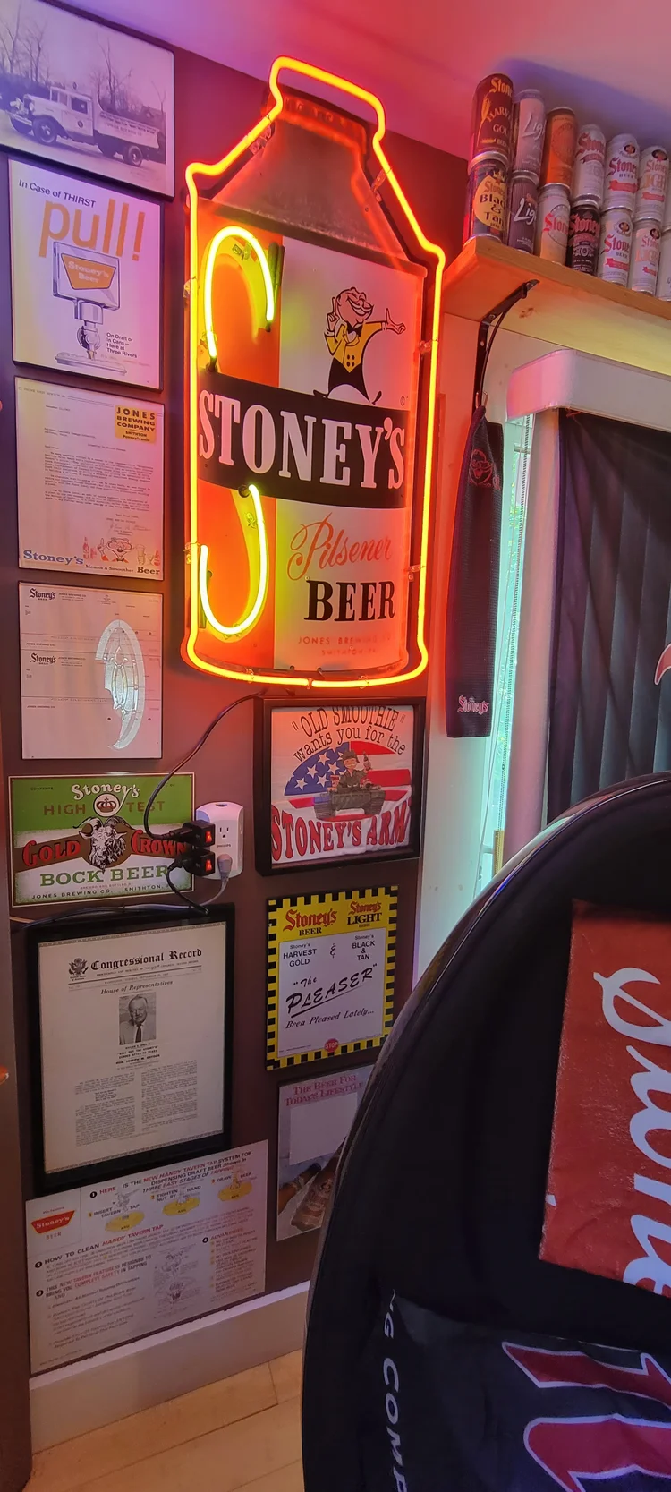 Lit Stoney's milk-can sign on a wall of framed pieces
