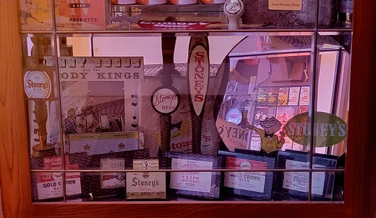 Glass case of Stoney's tap handles and Body Kings markers