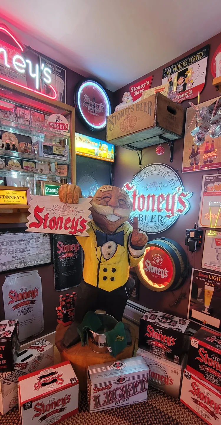 Stoney's signs and a Mr. Smoothie figure on a lit wall