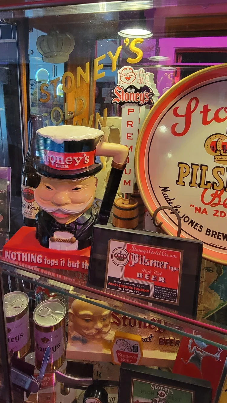 Lit case of Stoney's Pilsner signs and a Mr. Smoothie figure