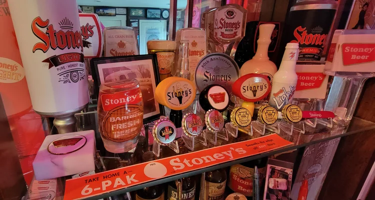 Cluster of Stoney's tap markers, buttons, and a six-pak sign