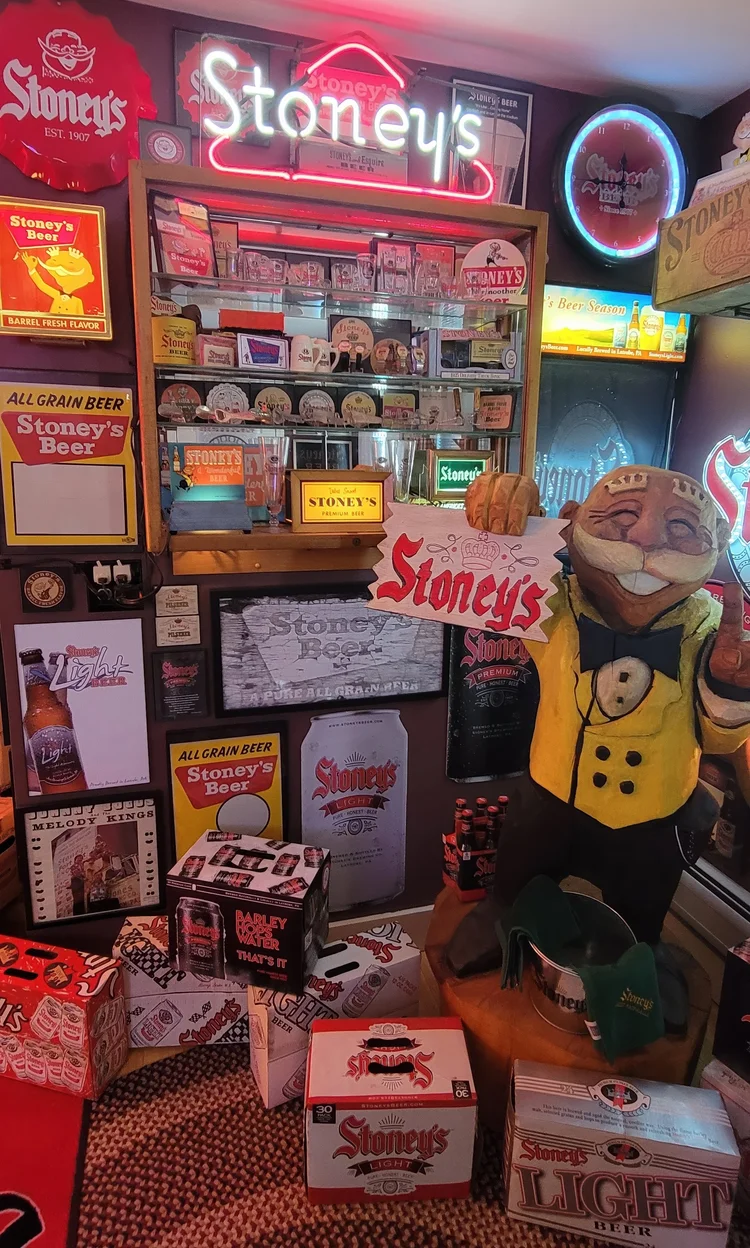 Wall display of Stoney's signs with a Mr. Smoothie figure