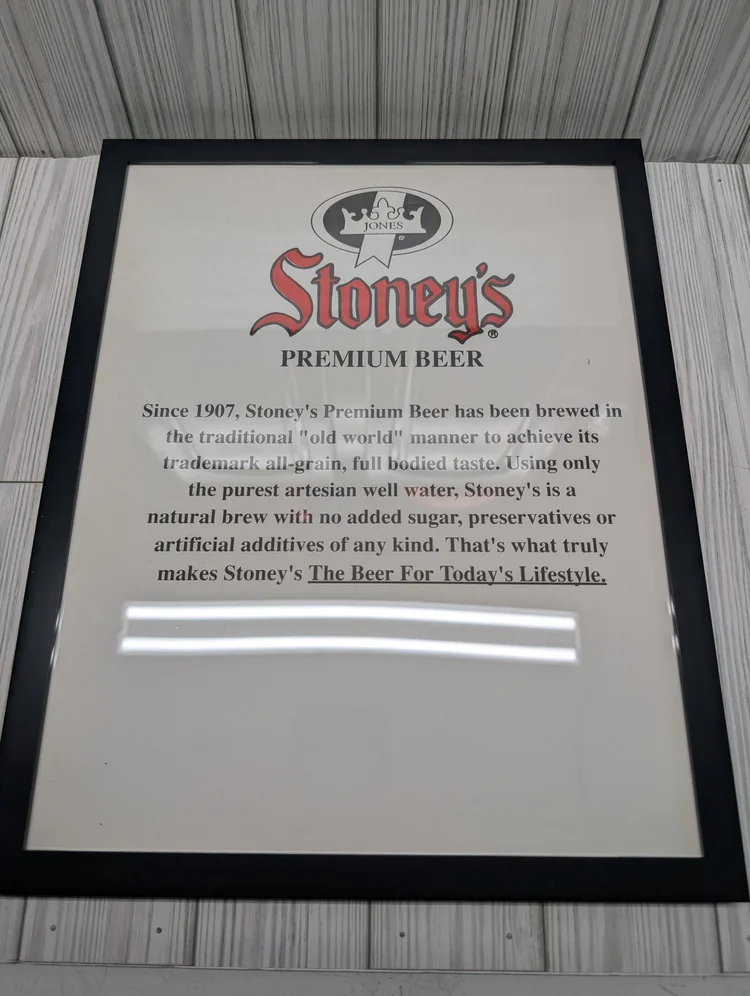 Framed Stoney's Premium Beer sign describing natural all-grain brewing